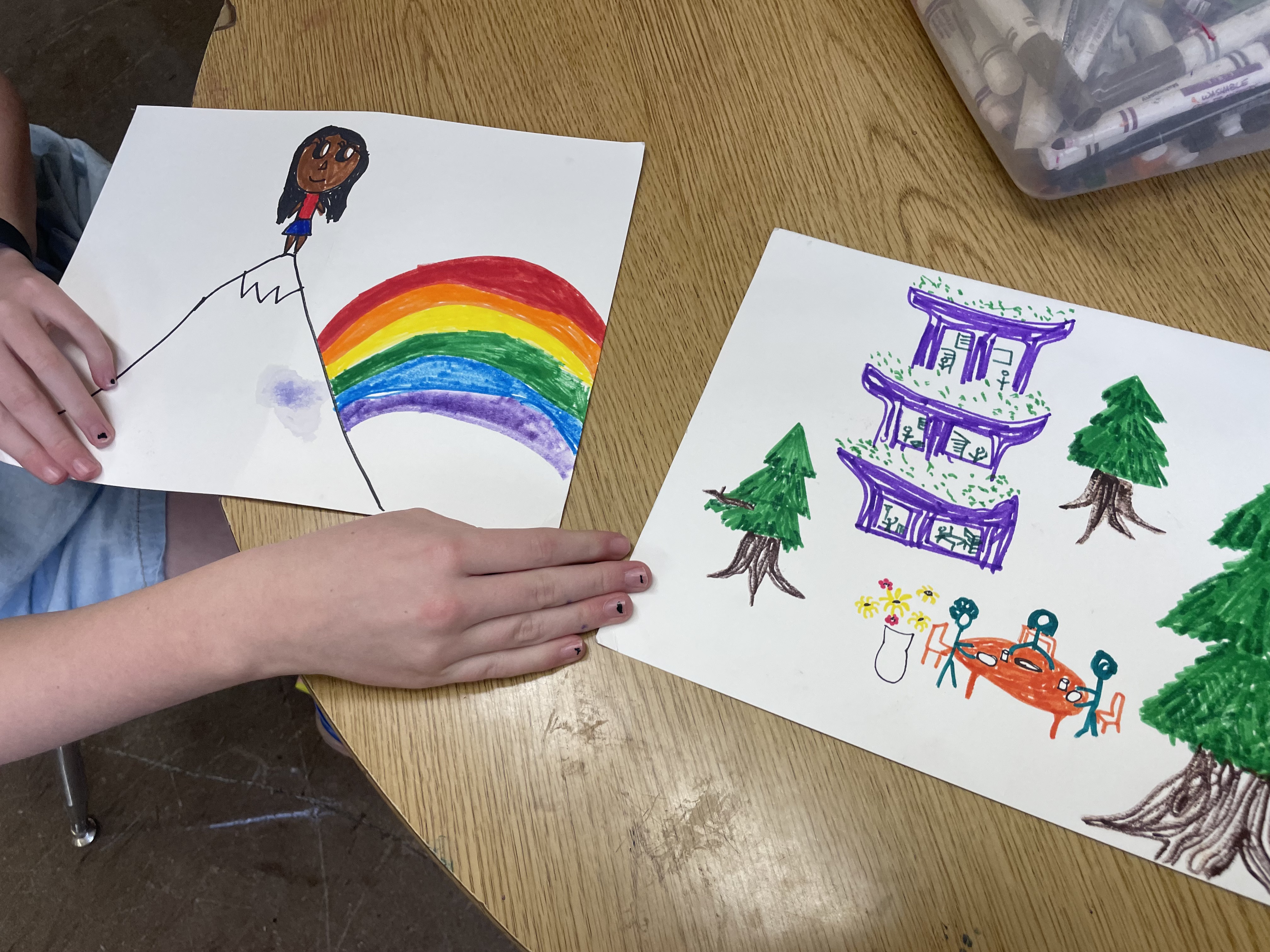 alice's drawing of Kamala on a mountain top under a rainbow