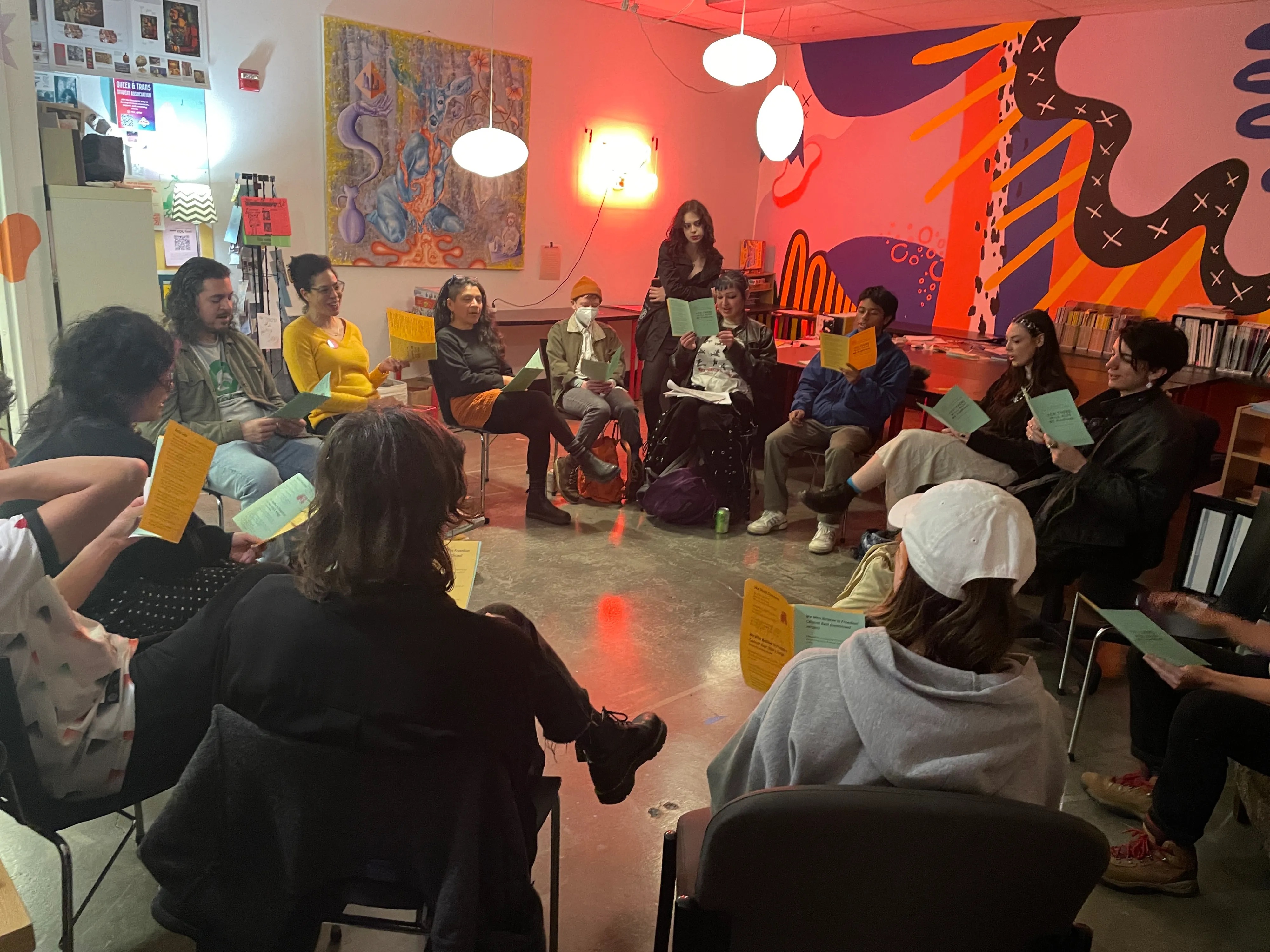 a circle of seated people with song sheets