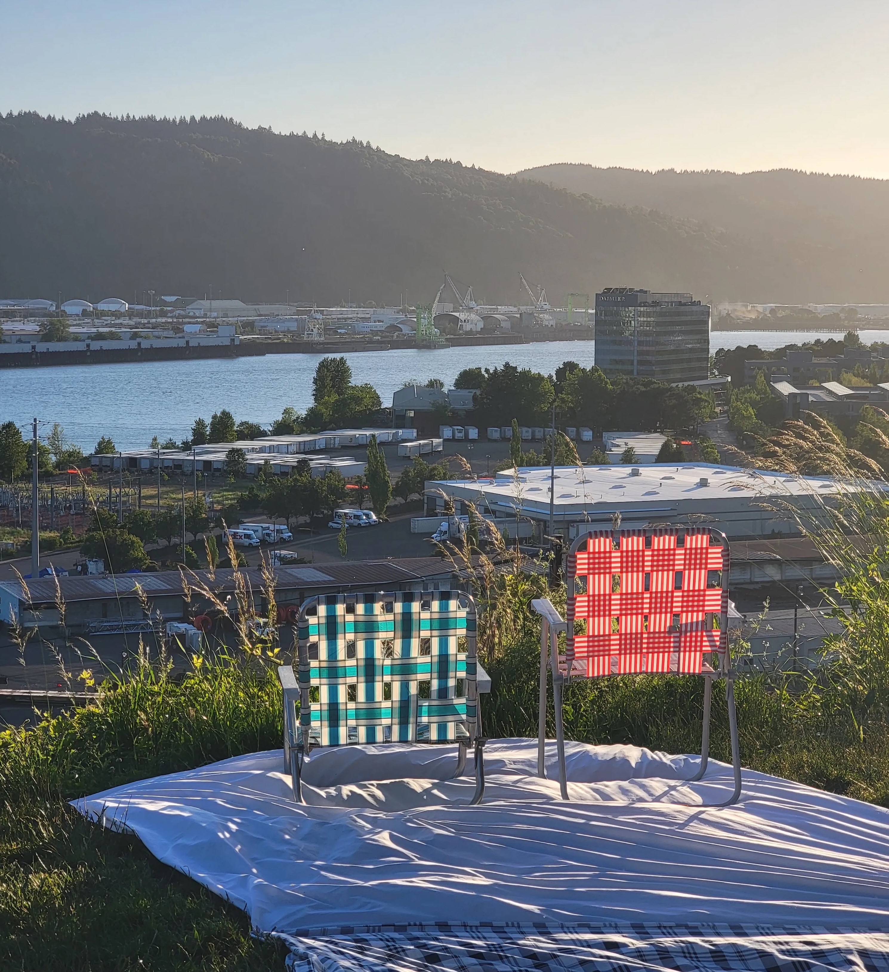 two lawn chairs looking out over the sunset