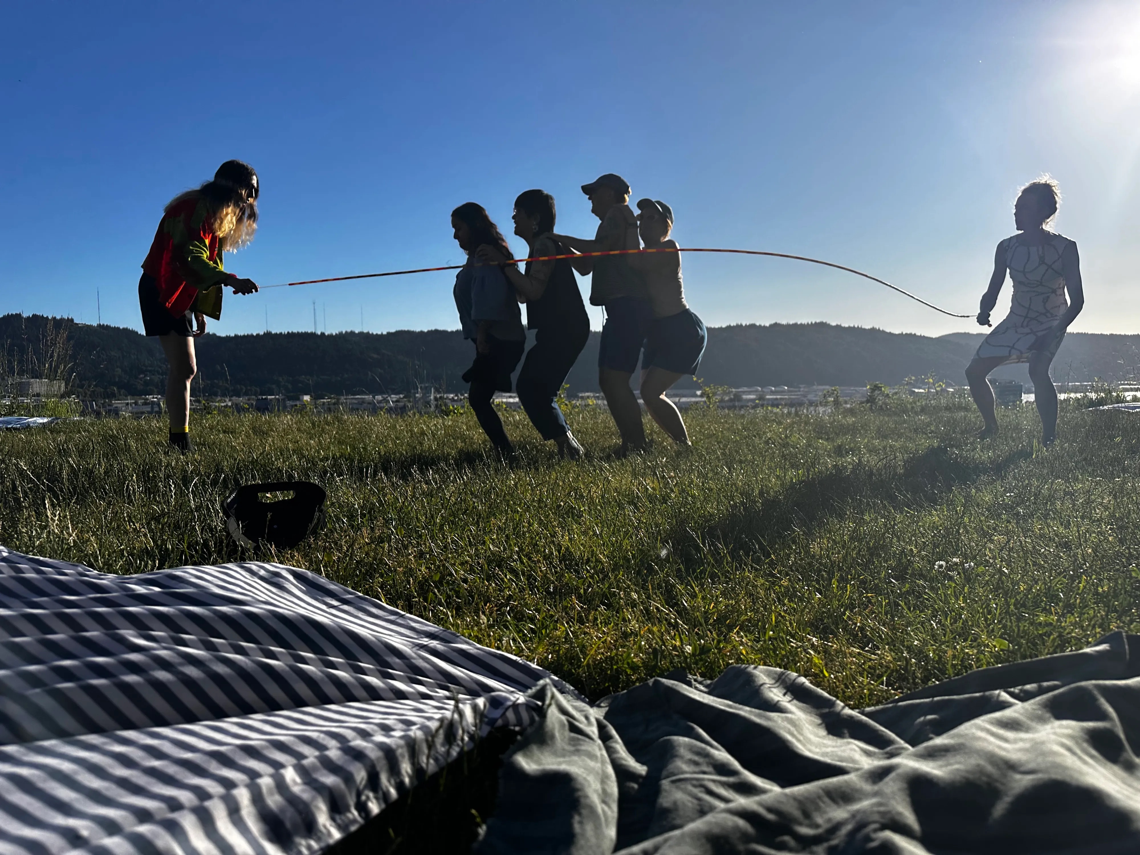 people jumping rope against the setting sun
